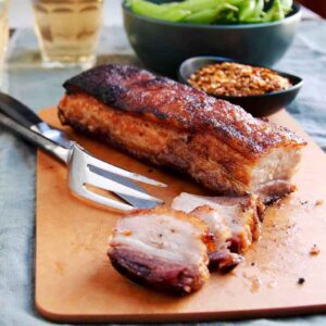 A view of a roasted pork belly with a fork 