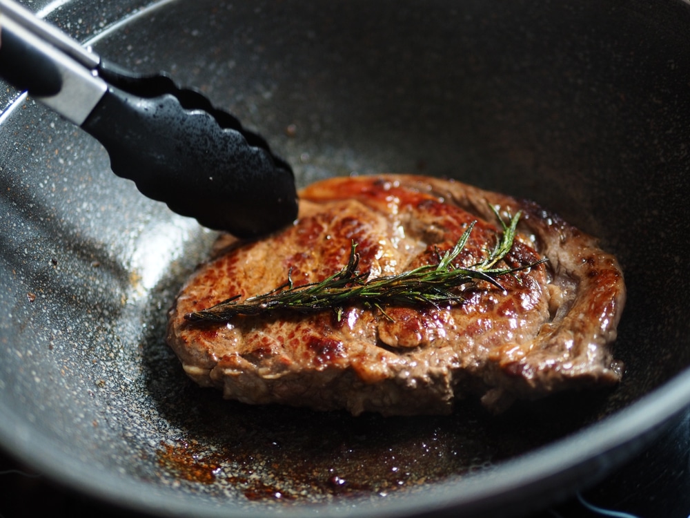 Cooking pan seared ribeye steak with rosemary in Korean granite stone coated frying pan