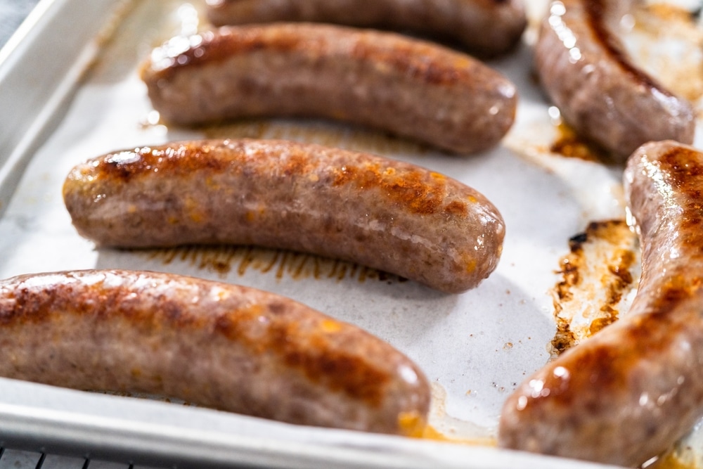 Freshly Cooked In Oven Beer Bratwursts On A Baking Sheet