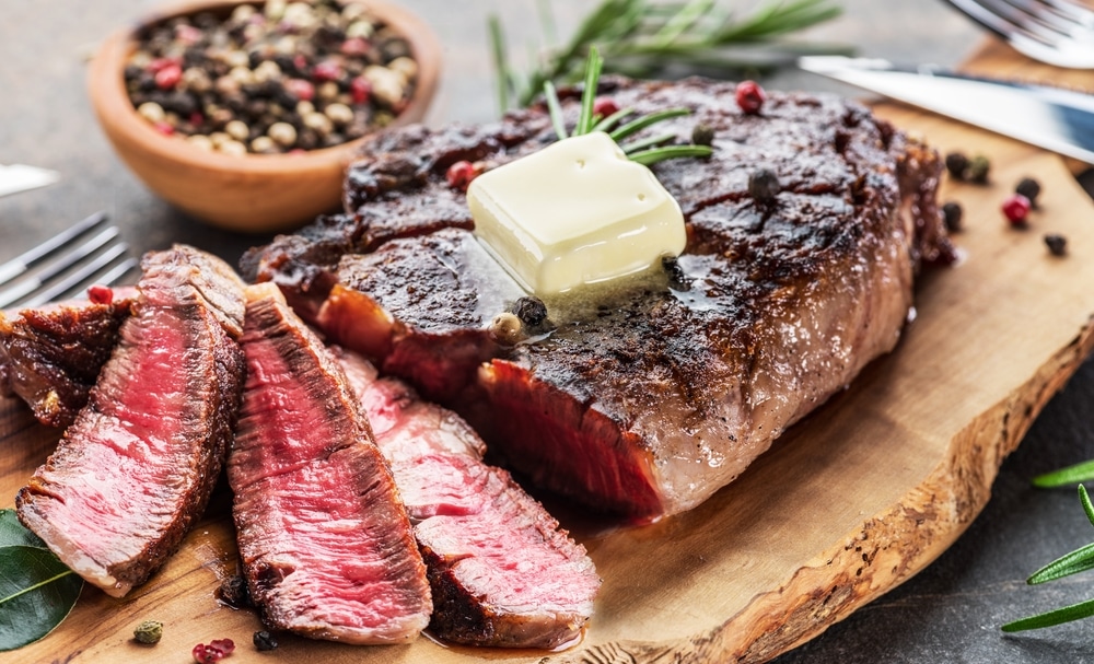 Grilled Medium Rare Ribeye Steak Slices With Melting Butter On