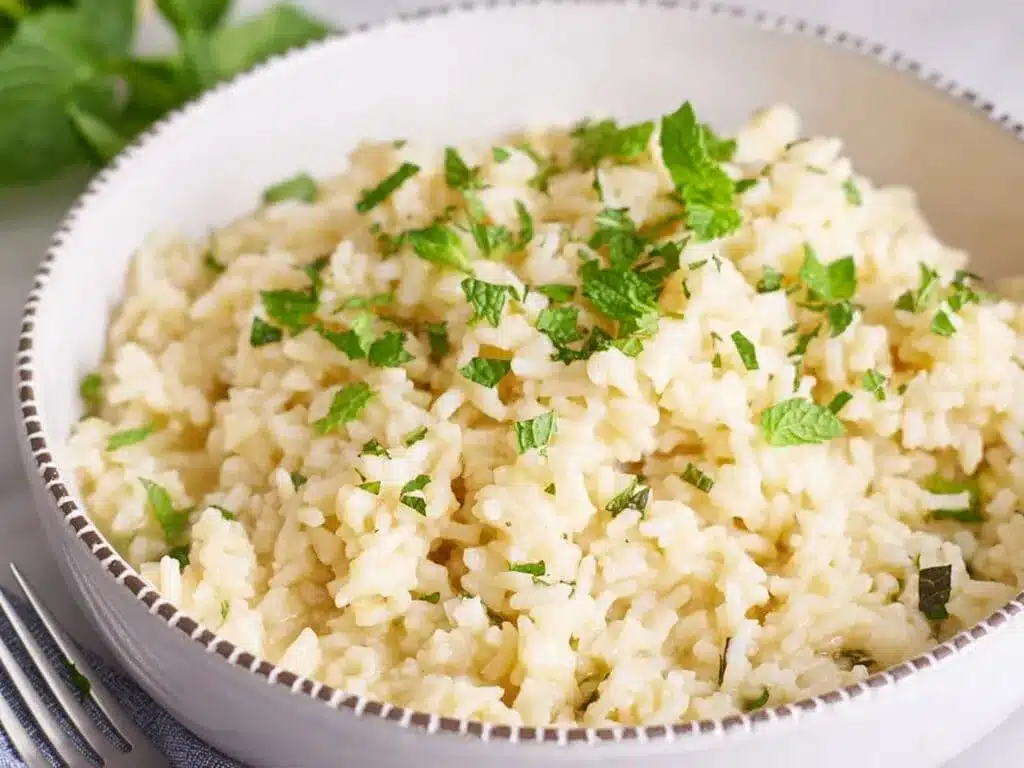 a bowl of cooked white rice in chicken broth