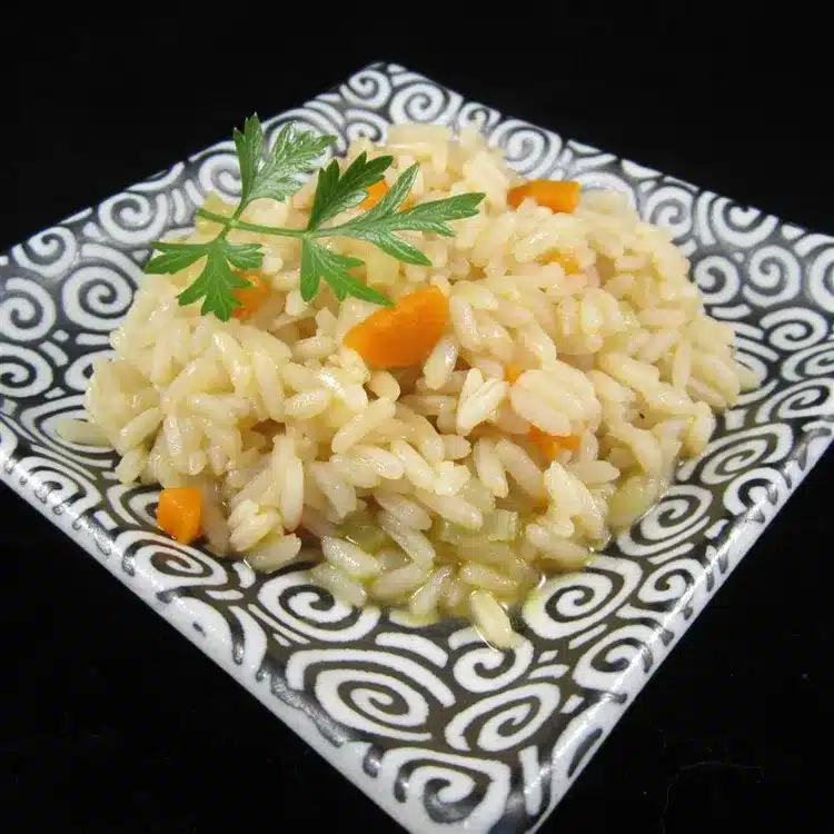 baked rice cooked in a broth served in a monochrome dish