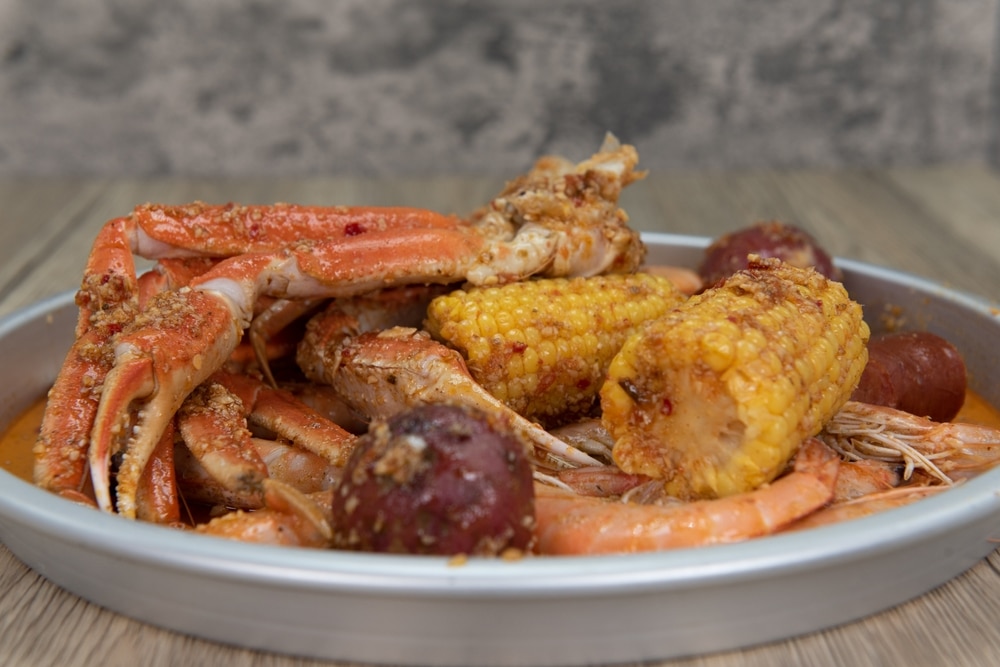 Delicious Buttery Plate Of Boiled Snow Crab Legs With Corn