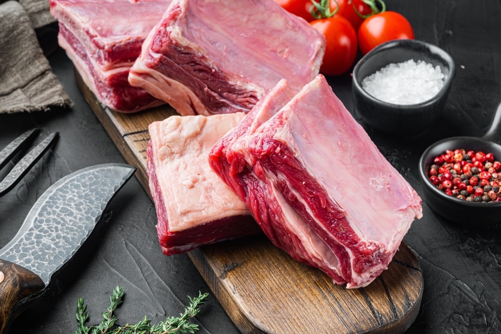 Raw Meat Ribs Set With Ingredients On Black Stone Background