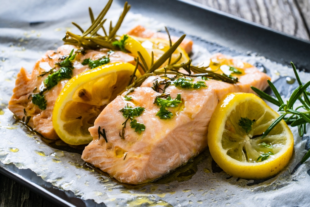 Roasted Salmon Steak With Lemon And Onion Served On Black