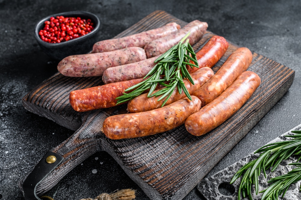 Assorted Raw Chorizo Sausages On A Wooden Cutting Board 