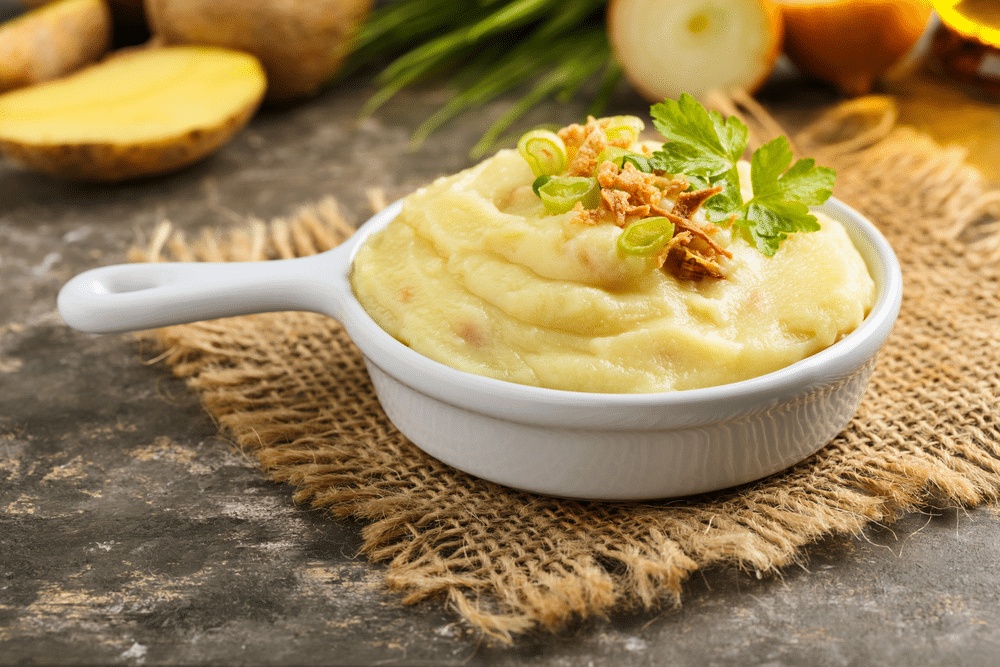 Mashed potatoes with roasted onions served in a small bowl