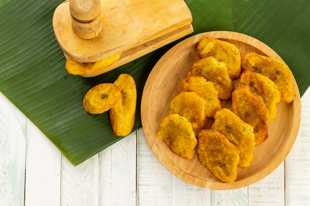 Patacones Or Tostones Fried Green Plantains On A Wooden Background